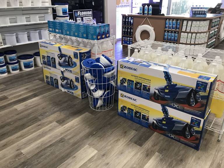 Pool cleaners and chemicals on the store floor at The Pool Palace